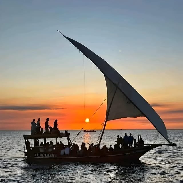 Traditional dhow sailing at sunset off the coast of Zanzibar