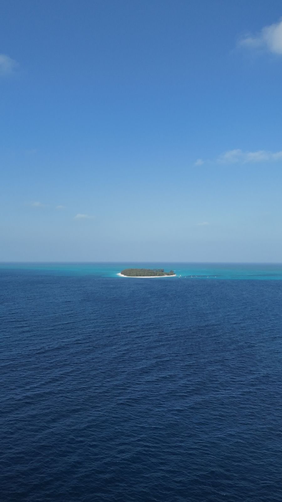 Mnemba Atoll island surrounded by the deep blue Indian Ocean