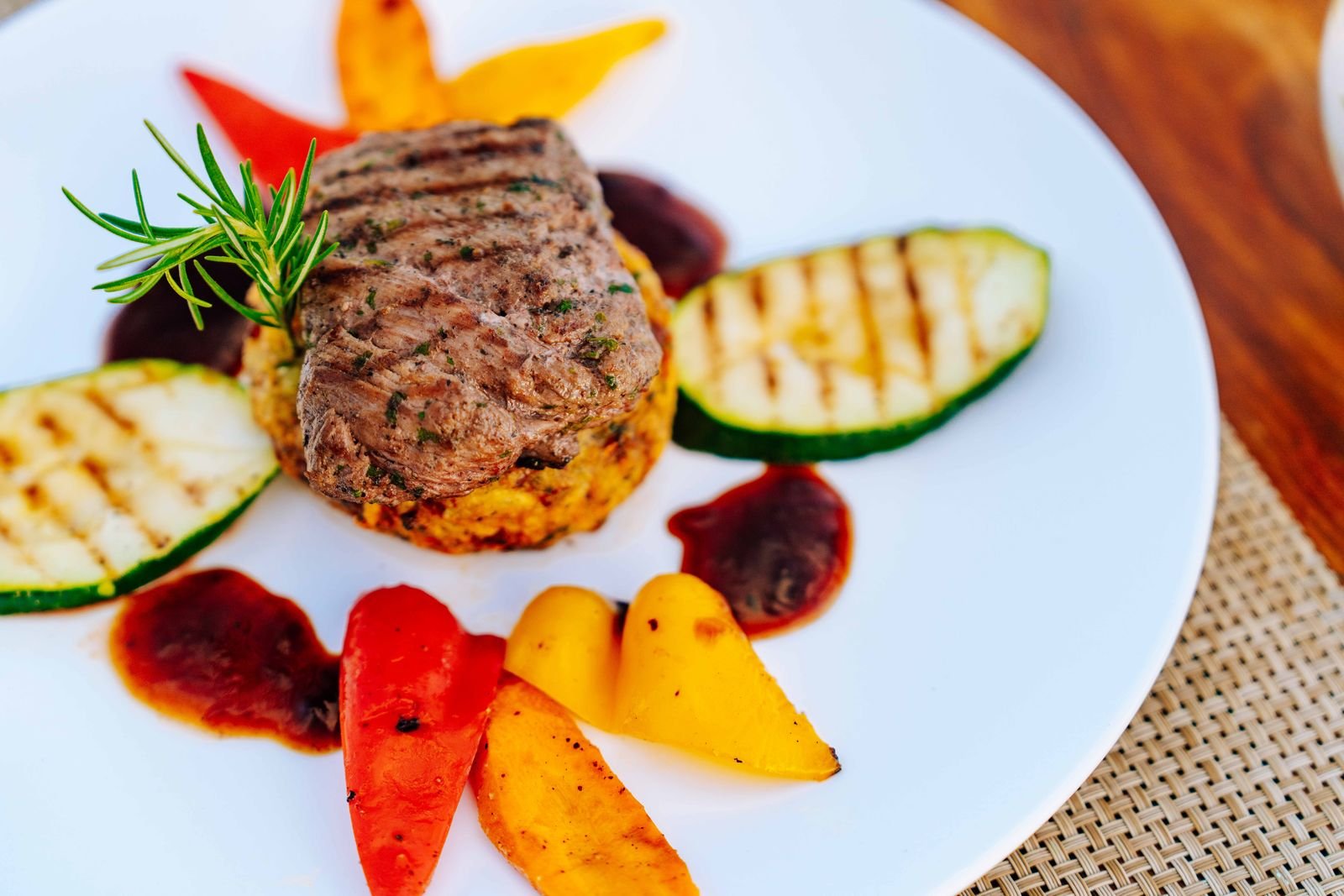 Grilled steak with roasted vegetables on a white plate