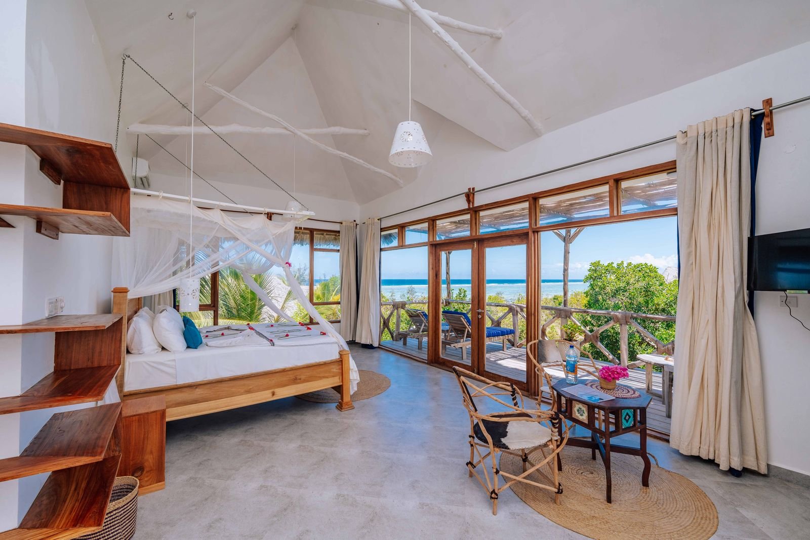 First Floor Sea View Room with a canopy bed and wide windows looking out to the ocean
