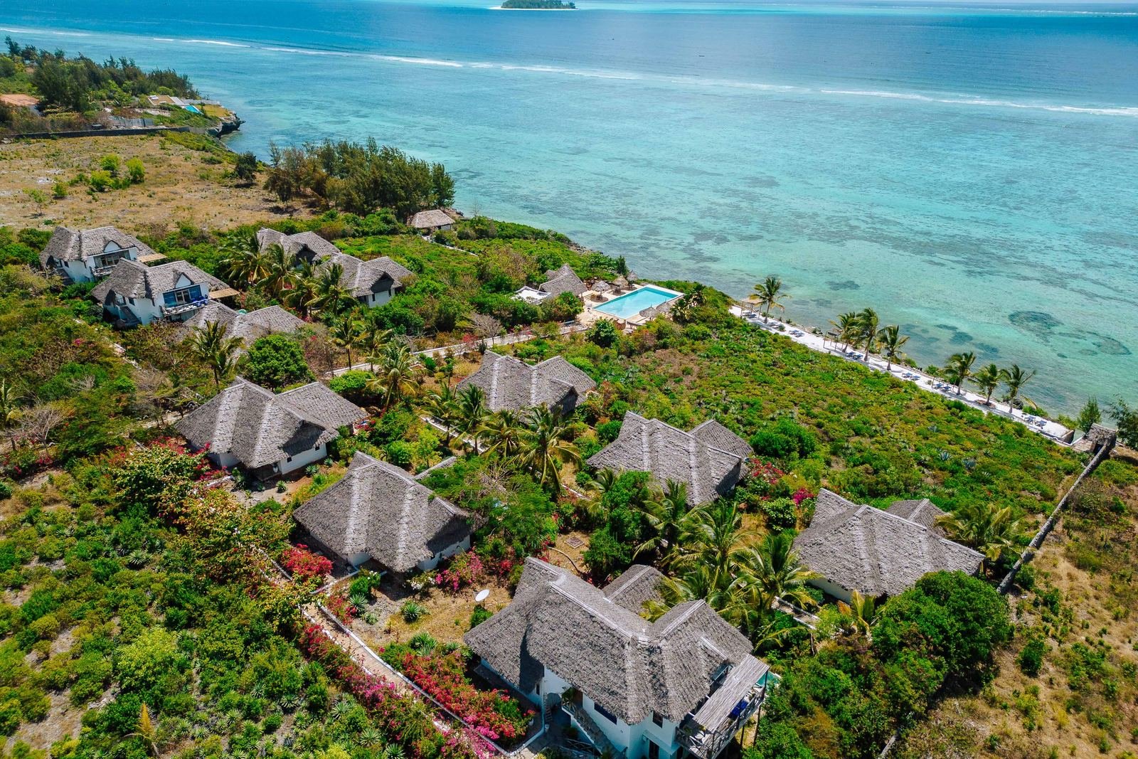 Aerial view of Kasha Boutique Hotel's thatched villas, gardens and the reef along the Matemwe coast