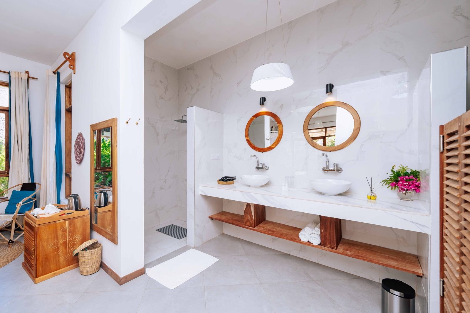 Garden Room bathroom with twin basins and round wooden mirrors