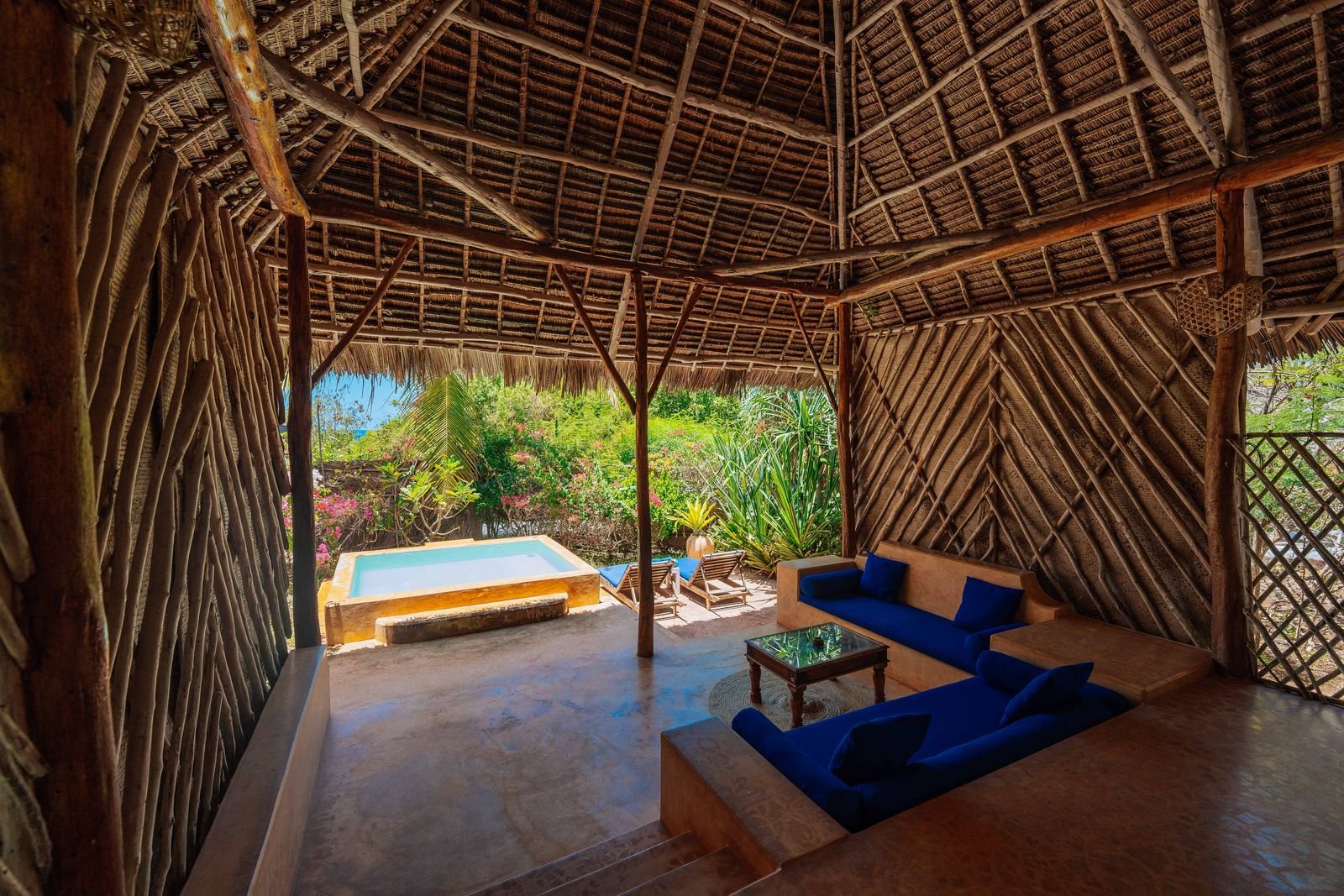 Partial Sea View Room terrace under a thatched roof with blue sofas and a private plunge pool