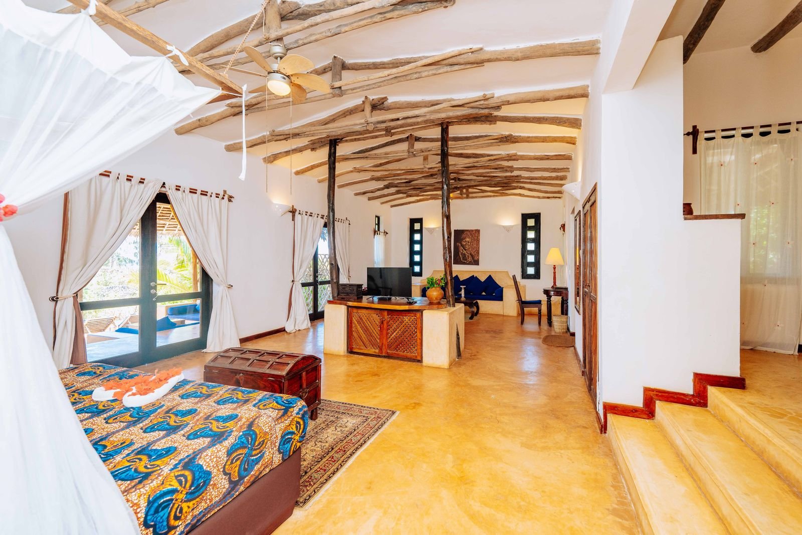Partial Sea View Room with a canopy bed, colourful bedspread and sitting area