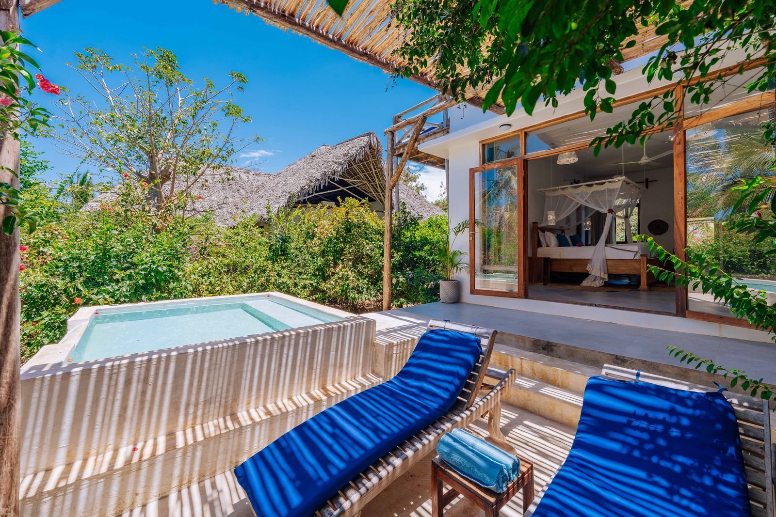 Garden Room terrace with a private plunge pool and loungers among tropical greenery