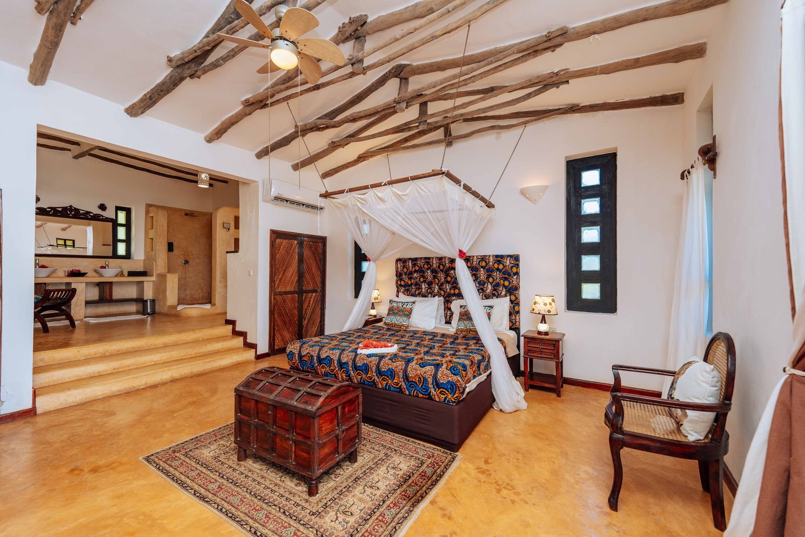 Partial Sea View Room with a canopy bed, Swahili chest and colourful African bedspread