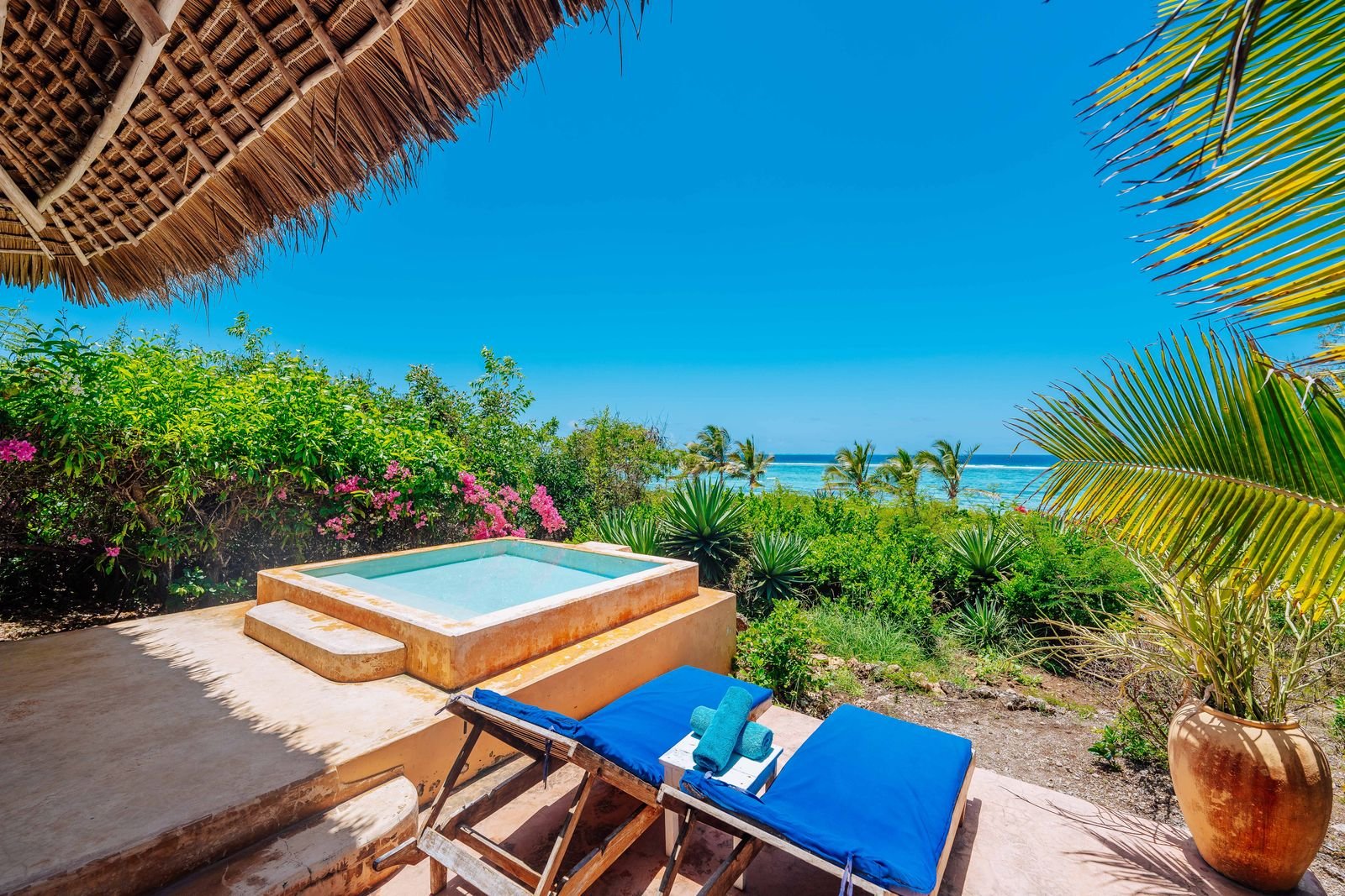 Private plunge pool and blue sun loungers on a Sea Front Villa terrace facing the Indian Ocean